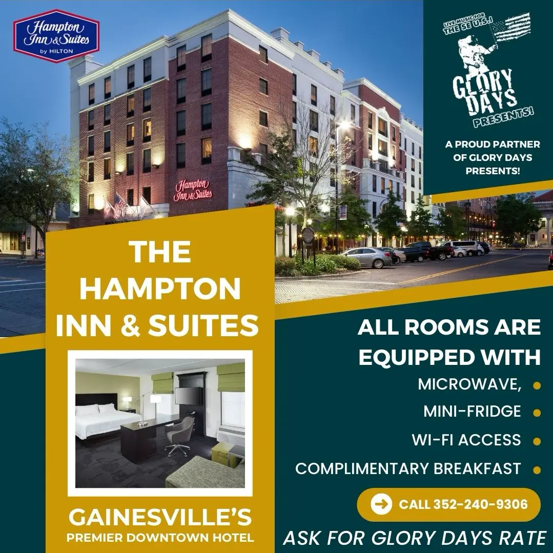 An advertisement featuring the brightly lit exterior of the downtown Hampton Inn & Suites hotel and an inset photo of a modern guest room.